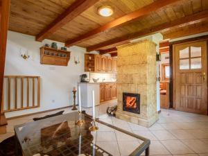 a kitchen with a stone fireplace and a stove at Holiday Home Sianowska Huta by Interhome in Pomieczyno