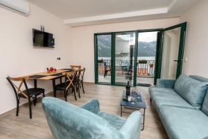 a living room with a couch and a table at Palamida apartments in Banovina