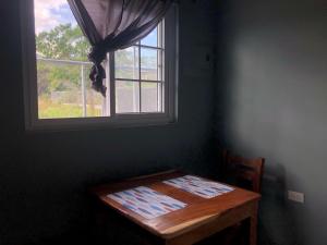 a room with a wooden table and a window at DeGattis House in Cañas