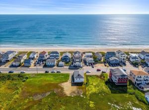 an aerial view of a beach with houses and the ocean at Sun2Sand Beach House in Salisbury
