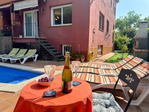 a bottle of wine on a table next to a pool at Holiday Home La Victoria by Interhome in Palafrugell
