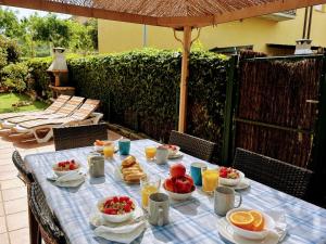 a table with food on a blue checked table cloth at Holiday Home La Victoria by Interhome in Palafrugell