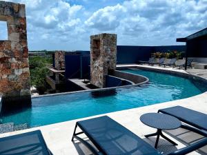 a swimming pool on top of a building at Paramar Black Condominio en Tulum in Tulum