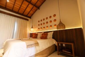 a bedroom with a large bed in a room at Casa dos Corais Patacho in Pôrto de Pedras +24 photos