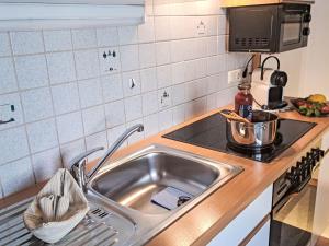 a kitchen with a sink and a stove at Apartment Dankl by Interhome in Fusch an der Glocknerstraße +47 photos