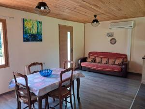 a room with a table and chairs and a bed at Gîte des giblins - Saint Amand en Puisaye in Saint-Amand-en-Puisaye