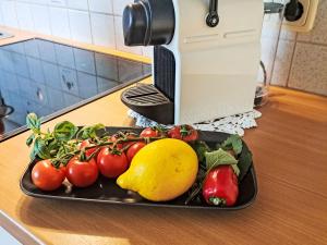 a plate of fruit and vegetables on a counter at Apartment Dankl by Interhome in Fusch an der Glocknerstraße