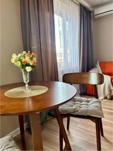a vase of flowers on a table in a room at Квартира-студия в центре города in Balqash +8 photos