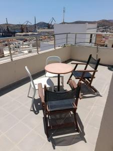 a table and chairs on top of a roof at House 8 in Ermoupoli