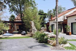a house with a palm tree in the yard at Villaverde Village in Santillana del Mar