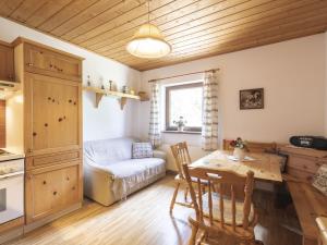 a kitchen and living room with a table and a couch at Holiday Home Landhaus Rittisweid by Interhome in Schladming +30 photos