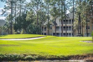 a golf course with a green and a building at Spacious with golf and wildlife views 1233-4 in Sampson