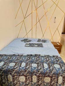 a bed with a quilt on it in a room at 3 Bedroom Dakar Plateau View of Gorée in Dakar +78 photos