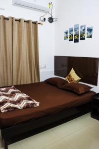 a bed in a room with a curtain and a bedvisor at Bollywood House 100 inch Cinema Jacuzzi Party Couples in Gurgaon