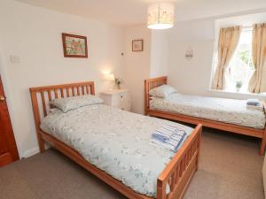 En eller flere senge i et værelse på Fairhaven Cottage