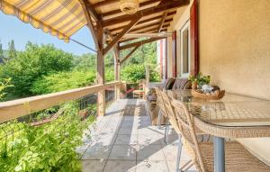 a patio with a table and chairs on a balcony at Cozy Home In Les Eyzies in Les Eyzies-de-Tayac +32 photos