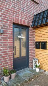 a front door of a brick building with a sign on it at Auszeit am Moor in Duvensee