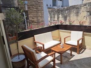 two chairs and a table on a balcony at Suite Verdi in Lecce +20 photos