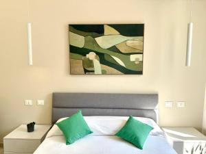 a bedroom with a bed with a painting above it at Scalette e Tramonti in Tropea