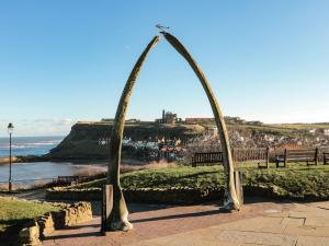 a couple of archways in a park near the ocean at Caedmon's Rest in Whitby