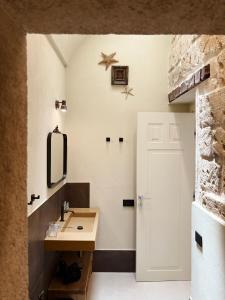 a bathroom with a sink and a mirror at Dimora Spugnara in Lampedusa +35 photos