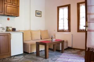 a living room with a couch and a table at Φιλυρέα Apartments - Room 4 in Zagora