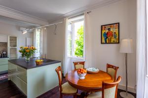 a kitchen and dining room with a wooden table at Appartement "La Marquise" centre de Grignan in Grignan
