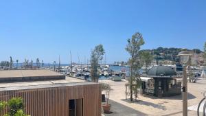 a view of a marina with boats in the water at Joli T2 sur le petit port de Sanary, Clim, superbe vue, au cœur du village in Sanary-sur-Mer