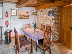 a dining room with a table and chairs at Gull Newk in Flamborough