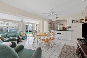 un salon avec un canapé, une table et des chaises dans l'établissement Little Venice Paradise - Waterfront Home, 55' Dock, à Marathon