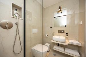 a bathroom with a shower and a toilet and a sink at Kruna apartments est 2024 in Split +31 photos
