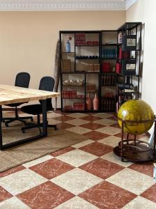 a room with a table and chairs and a book shelf at Ocean House in Ferrel +16 photos