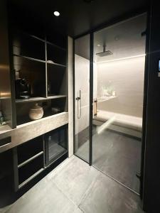 a bathroom with a shower and a glass door at Unique Cabin With Spa And Ski In-Ski Out in Hemsedal