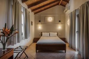 a bedroom with a bed in a room with windows at Villa Apollo in Parga +124 photos