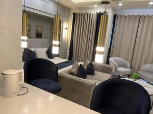 a living room with a bed and a couch at Elysium Tower Designer Apartments Facing Centaurus Mal Islamabad in Islamabad