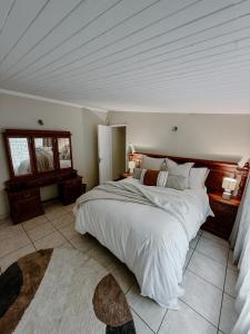 a bedroom with a large bed in a room at The Garden Den in Nelspruit