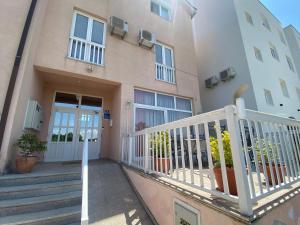 an apartment building with a balcony and a door at Guest House Regina Mundi in Međugorje