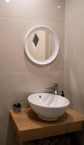 a bathroom with a white sink and a mirror at Gemini in Laganas