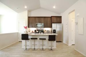 a kitchen with a island with bar stools at Lovely 2BR Home - Your Fort Collins Retreat! in Buckingham