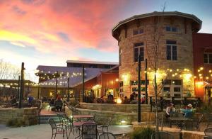 a group of tables and chairs in front of a building at Lovely 2BR Home - Your Fort Collins Retreat! in Buckingham