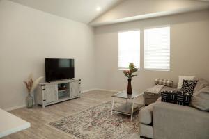 a living room with a couch and a flat screen tv at Lovely 2BR Home - Your Fort Collins Retreat! in Buckingham