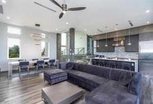 a living room with a couch and a kitchen at Off the Hook - Luxury Waterfront Pool Home, Kayaks & Bikes, 30' Dock in Marathon