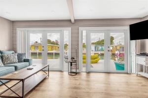 a living room with a couch and a table at Reel Deal - Waterfront Pool Home, 76' Dock in Marathon