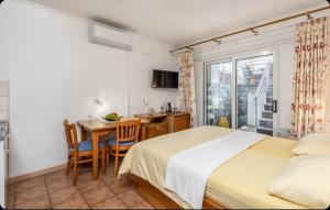 a bedroom with a bed and a table and a desk at Villa Ana Selce s bazenom i panoramskim pogledom na more in Selce +22 photos