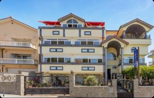 a large yellow building with a red roof at Villa Ana Selce s bazenom i panoramskim pogledom na more in Selce
