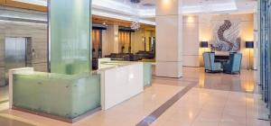 an office with glass columns and desks in a lobby at Staycation in style with fast Wifi Netflix in Manila +17 photos
