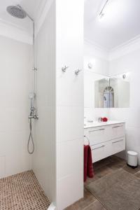 a white bathroom with a shower and a sink at Romantic Retreat in Prime Position in Acantilado de los Gigantes