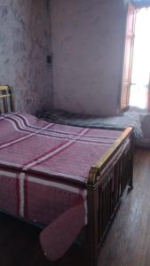 a bedroom with two beds in a room with a window at La Maison Enchantee in Humahuaca