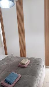 a bedroom with two towels on a bed at Spacious 2 BR appartment near mall -Internet 1Gbps in Paphos City