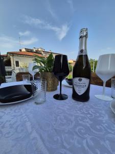 a bottle of wine sitting on a table with glasses at Superior Suite, Villa Joy Verona, Luxury Romantic Suite with Jacuzzi, near City Center in Verona